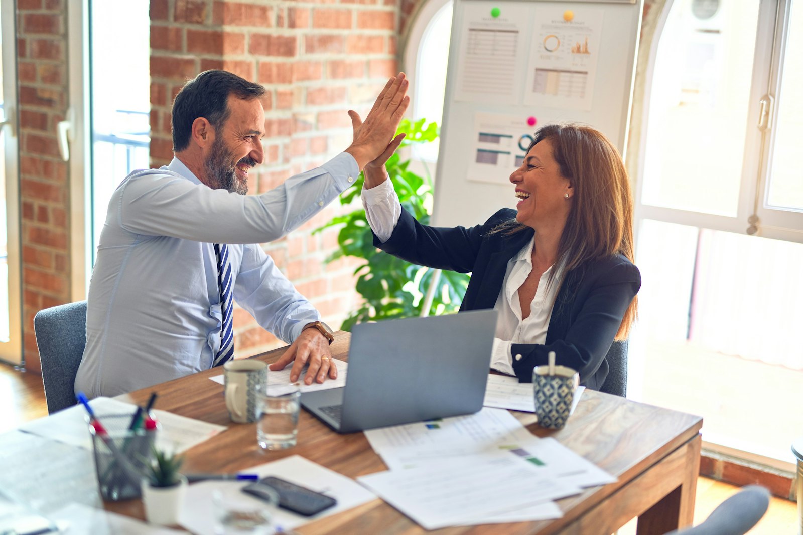 A team working together at a desk in a bright office